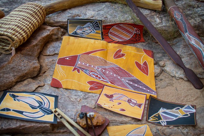 Photos of cultural artifacts. Indigenous paintings and basketweaving. 