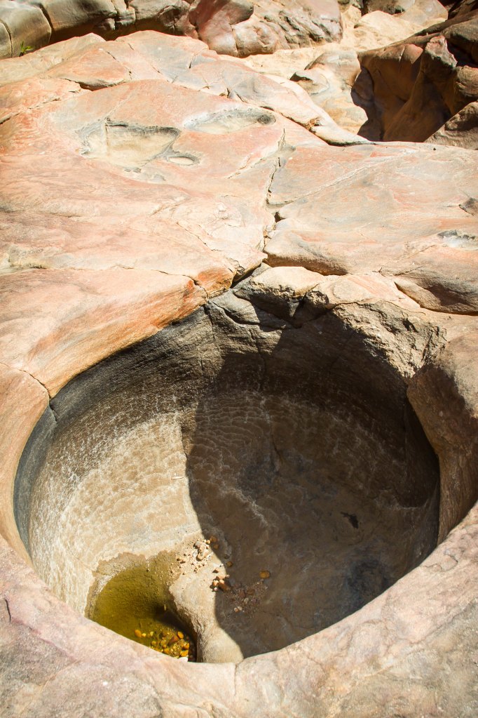 These 'vortex' holes are caused by the water throughout the wet season that swirl round and round drilling into the rock. 